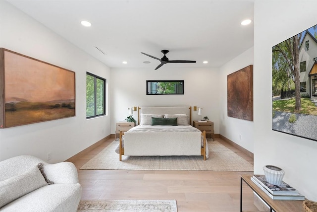 bedroom with ceiling fan and light hardwood / wood-style floors