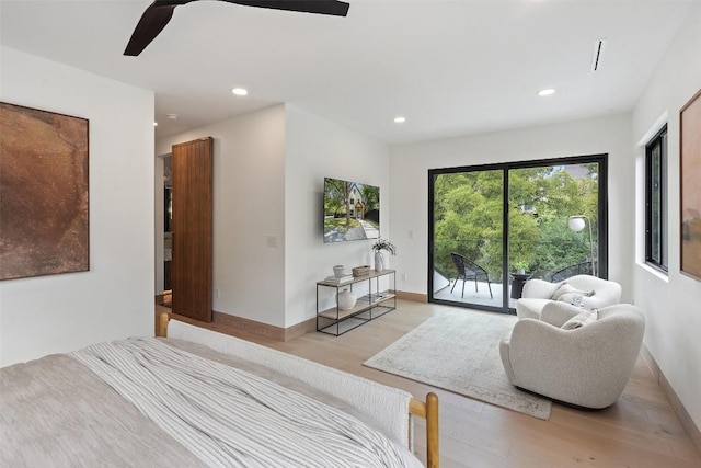 bedroom with access to outside, light hardwood / wood-style floors, and ceiling fan