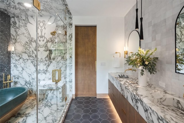 bathroom with sink, tile walls, and an enclosed shower