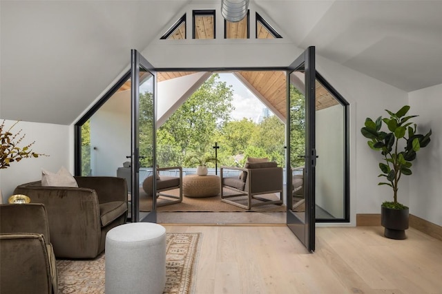 doorway with lofted ceiling and light hardwood / wood-style flooring