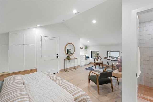 bedroom featuring lofted ceiling and light hardwood / wood-style floors