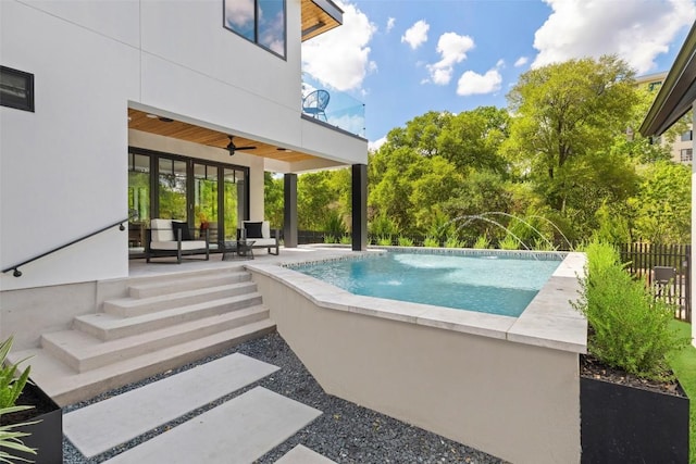 view of pool with an outdoor hangout area, a patio area, and ceiling fan