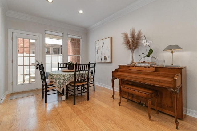 dining space featuring light hardwood / wood-style flooring and ornamental molding