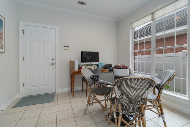 tiled dining space with a wealth of natural light and ornamental molding