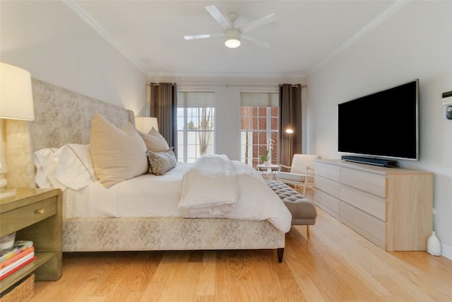 bedroom with ceiling fan, wood-type flooring, and ornamental molding