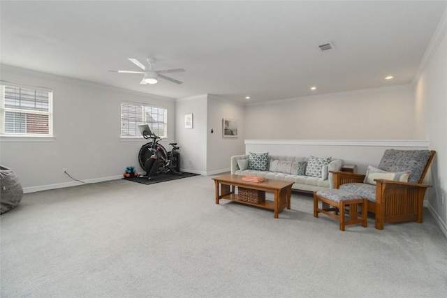 carpeted living room with ceiling fan and ornamental molding