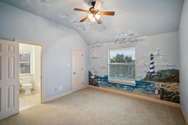 bedroom featuring connected bathroom, light colored carpet, vaulted ceiling, and ceiling fan