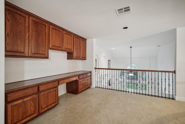 unfurnished office with a chandelier, light carpet, and vaulted ceiling