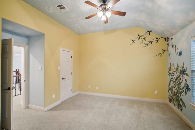 carpeted empty room featuring ceiling fan and lofted ceiling