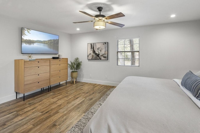 bedroom featuring ceiling fan and dark hardwood / wood-style floors