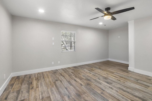 empty room with ceiling fan and hardwood / wood-style floors