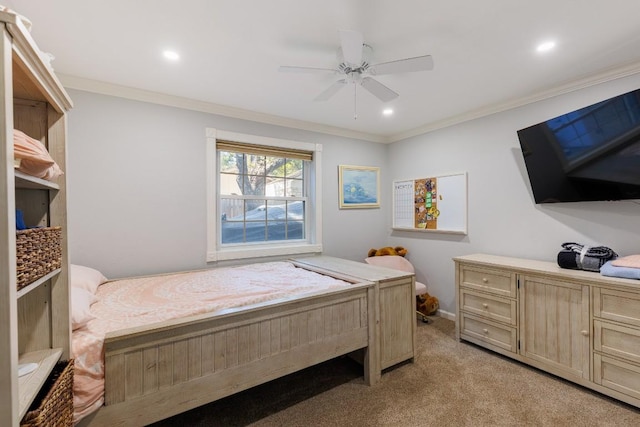 carpeted bedroom with ceiling fan and ornamental molding