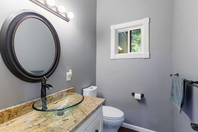 bathroom featuring vanity and toilet