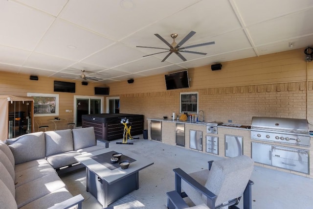 view of patio with area for grilling, an outdoor living space, and sink