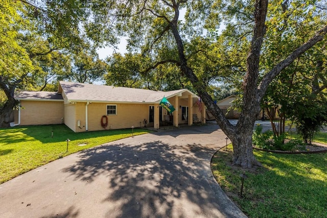 ranch-style home with a front lawn