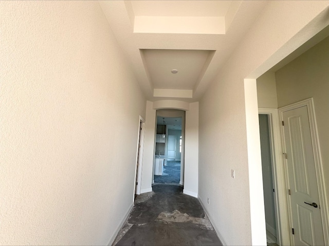 hall featuring a raised ceiling