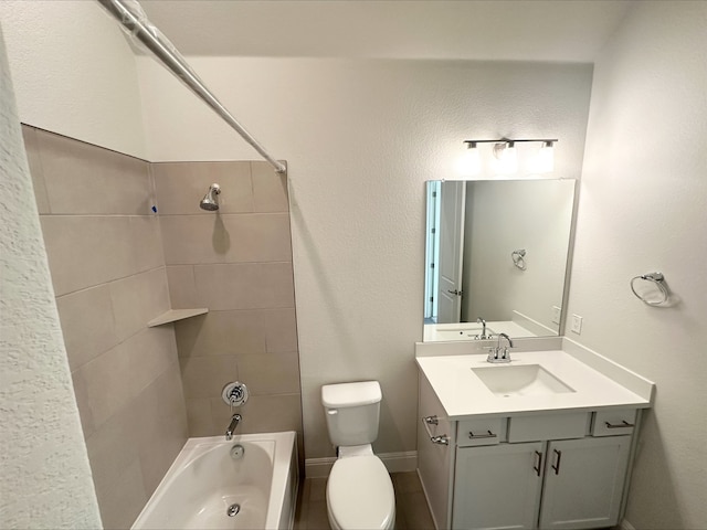 full bathroom featuring toilet, tiled shower / bath, and vanity