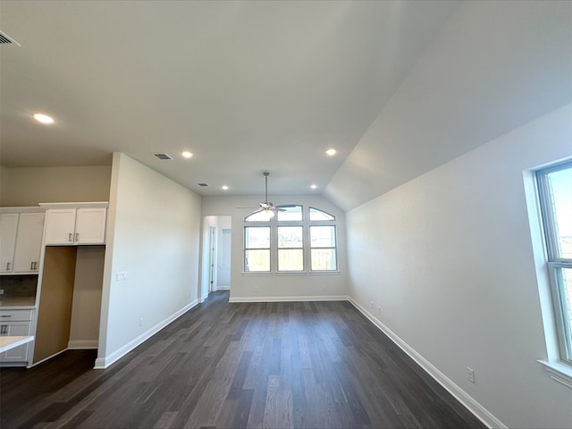 unfurnished living room featuring ceiling fan, dark wood-type flooring, and lofted ceiling