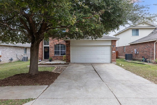 view of front of property with cooling unit, a garage, and a front lawn