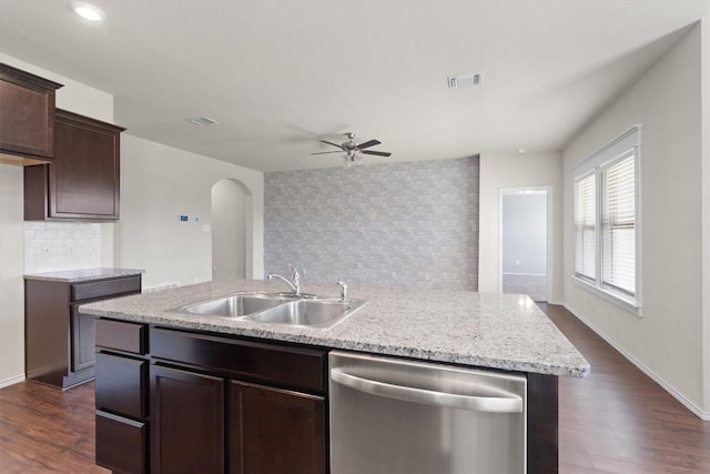 kitchen featuring dark hardwood / wood-style flooring, stainless steel dishwasher, a kitchen island with sink, and sink