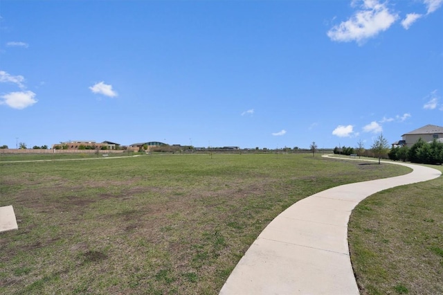 view of home's community with a yard