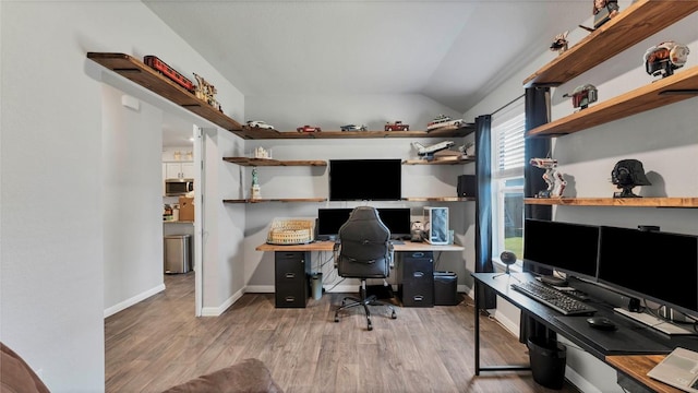 office area featuring wood-type flooring and vaulted ceiling