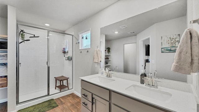 bathroom featuring wood-type flooring, vanity, and walk in shower