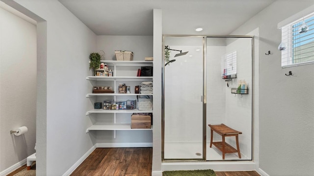 bathroom featuring hardwood / wood-style flooring and an enclosed shower