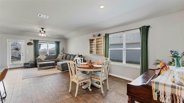 dining area with ceiling fan and dark hardwood / wood-style floors