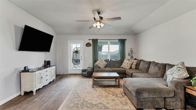 living room with hardwood / wood-style flooring, vaulted ceiling, and ceiling fan