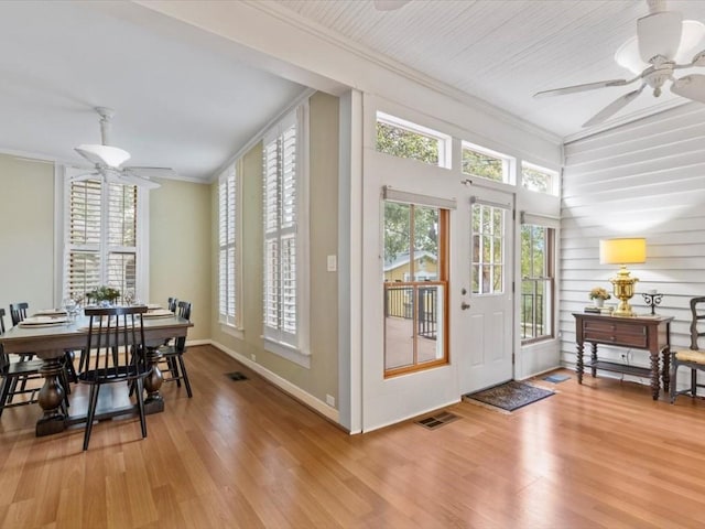 entryway featuring hardwood / wood-style flooring, ceiling fan, and ornamental molding