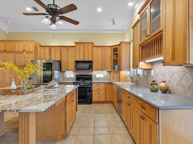 kitchen featuring black appliances, a kitchen island, crown molding, and sink