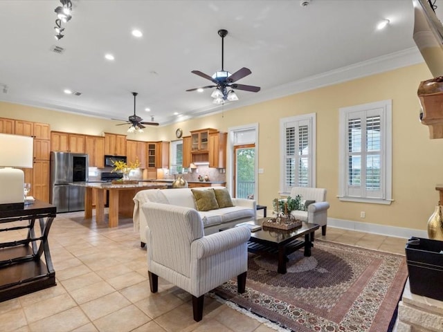 tiled living room featuring ceiling fan and ornamental molding