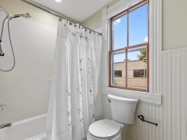 bathroom with shower / tub combo and toilet