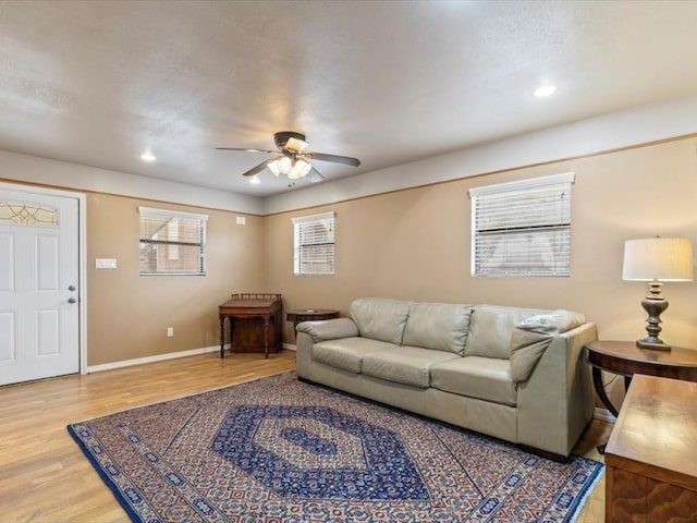 living room with hardwood / wood-style flooring, a wealth of natural light, and ceiling fan