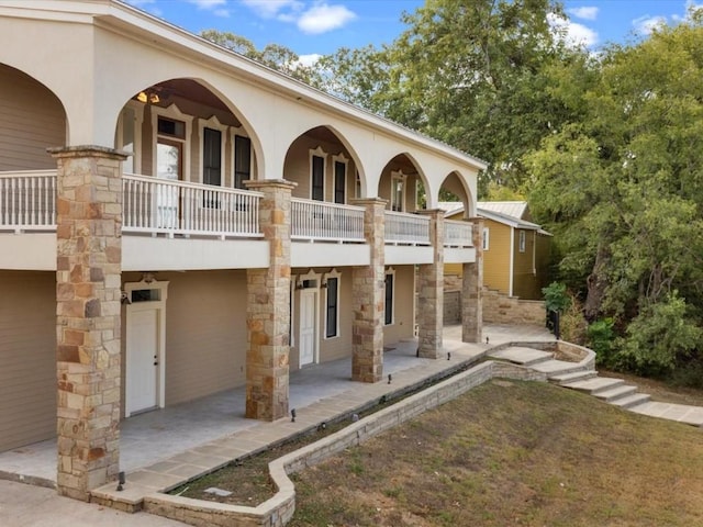 rear view of property with a patio and a balcony