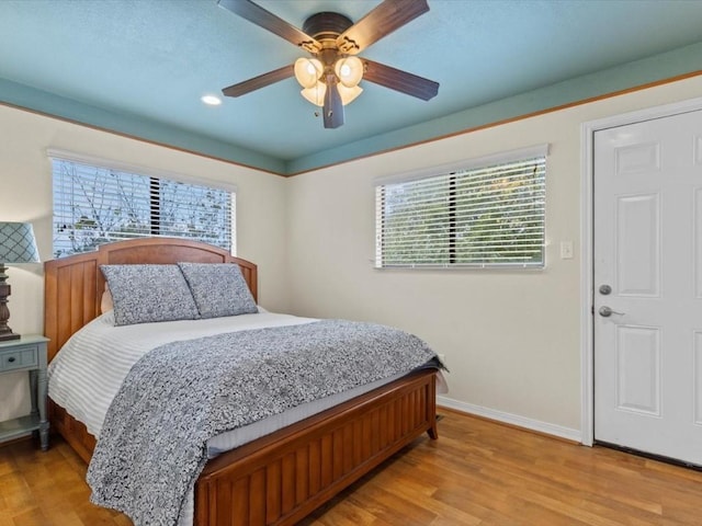 bedroom with ceiling fan and light hardwood / wood-style flooring