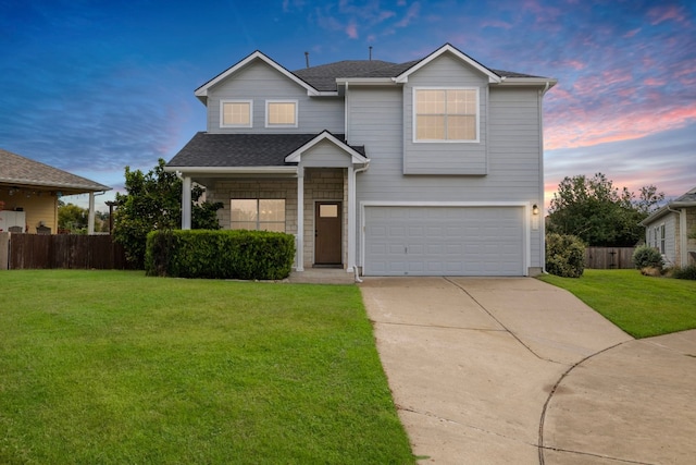 front facade featuring a lawn and a garage