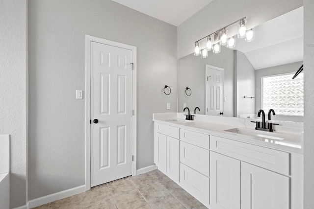 bathroom featuring vanity, tile patterned floors, and lofted ceiling