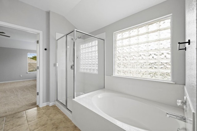 bathroom with tile patterned floors, shower with separate bathtub, and vaulted ceiling