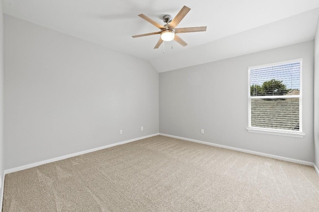 carpeted spare room with vaulted ceiling and ceiling fan