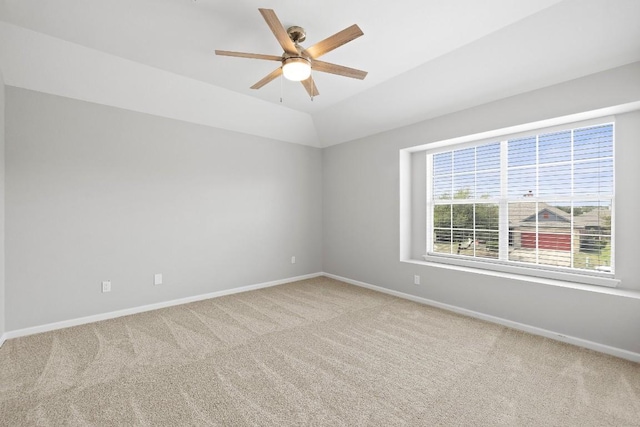 carpeted empty room with ceiling fan and vaulted ceiling