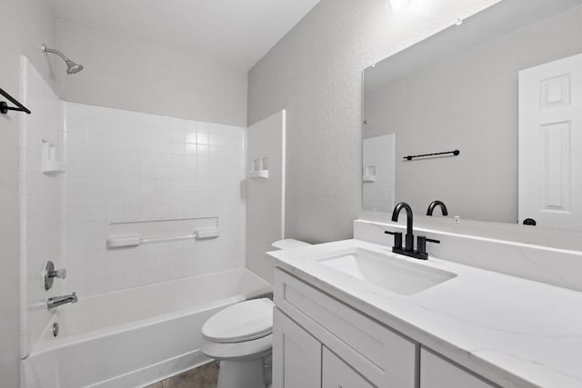 full bathroom featuring vanity, tiled shower / bath combo, and toilet