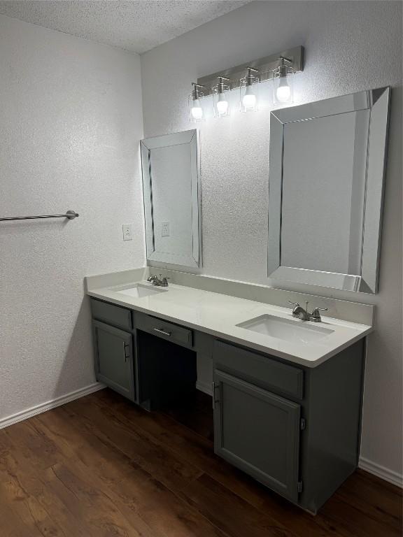 bathroom with vanity, hardwood / wood-style floors, and a textured ceiling