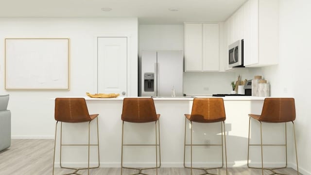 kitchen featuring light wood-type flooring, white cabinetry, and fridge with ice dispenser