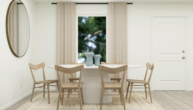 dining room featuring a wealth of natural light and light hardwood / wood-style floors