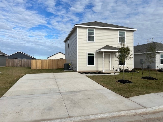 front facade with central AC unit and a front lawn