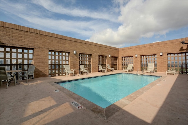 view of swimming pool with a patio area