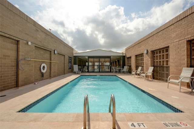 view of swimming pool with a patio area