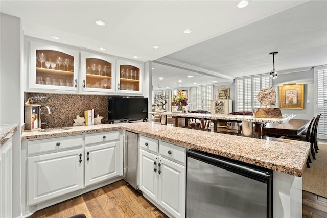 kitchen featuring kitchen peninsula, sink, white cabinets, light hardwood / wood-style floors, and wine cooler